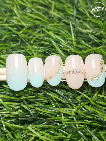 A soft and dreamy look. This set features a baby blue ombre with delicate gold flakes and a line of rhinestones for a subtle, elegant sparkle.