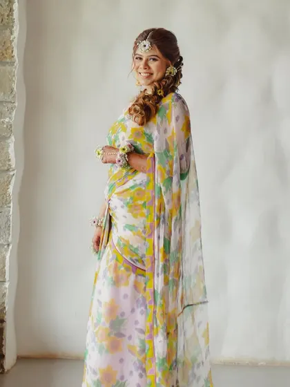 The same bride, showing how a few well-placed floral accessories can elevate a simple, printed saree for any special occasion.