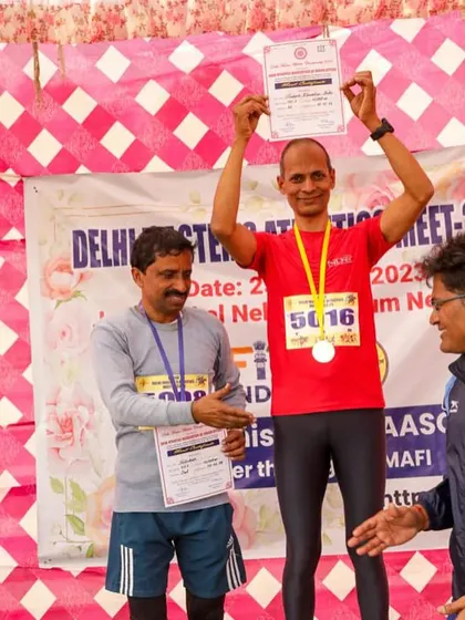 Celebrating a gold medal win at the Delhi Masters Meet. The joy of holding up the certificate and medal is unmatched.