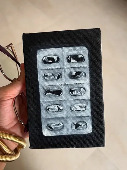 A small oil painting of a used blister pack of pills. This is another piece that finds a strange sort of beauty and story in a very mundane object.