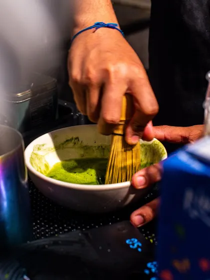 A shot of a barista at Bokka Coffee whisking matcha, showing the traditional and authentic preparation method.