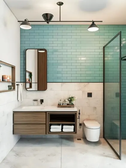 We used a refreshing aqua-colored subway tile as a feature wall in this bathroom. The floating wood vanity with a black countertop and fixtures provides a modern contrast, creating a clean and stylish space.