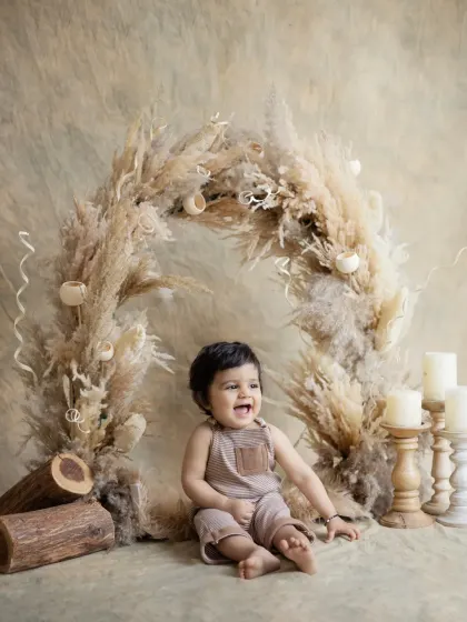 A big, open-mouthed laugh from this adorable baby. Capturing these moments of pure joy is what makes our job so rewarding.