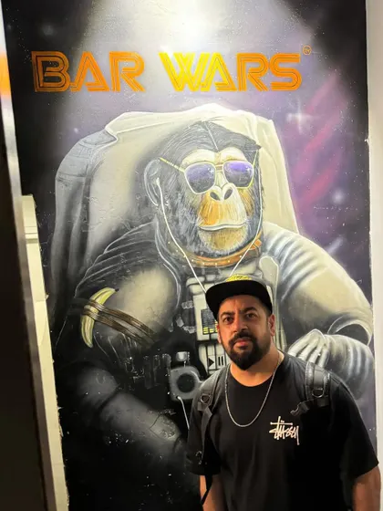 Posing with some 'Bar Wars' artwork. The creative decor in clubs is always an inspiration.