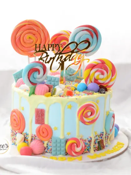 A candyland dream come true. This drip cake is overloaded with colorful lollipops, candies, and sprinkles for the ultimate sweet treat.