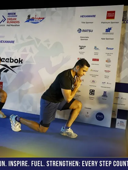 Demonstrating a lunge variation during the pre-race warmup. Proper preparation is key to a successful and injury-free run.