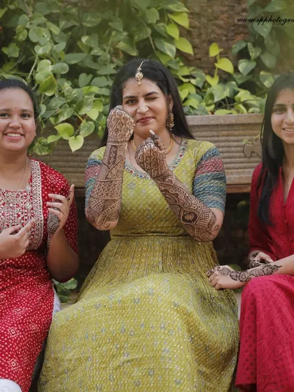 The bride and her friends showing off their beautiful Mehndi designs. These are the relaxed, happy moments that add so much richness to the wedding story.