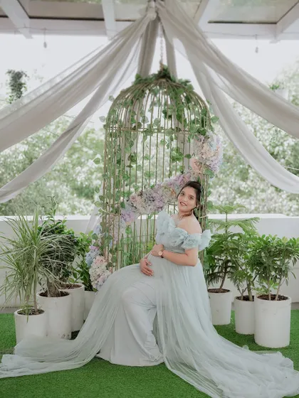 Our popular birdcage setup. Draped with soft fabric and adorned with flowers, it creates a romantic and whimsical backdrop for any gown.