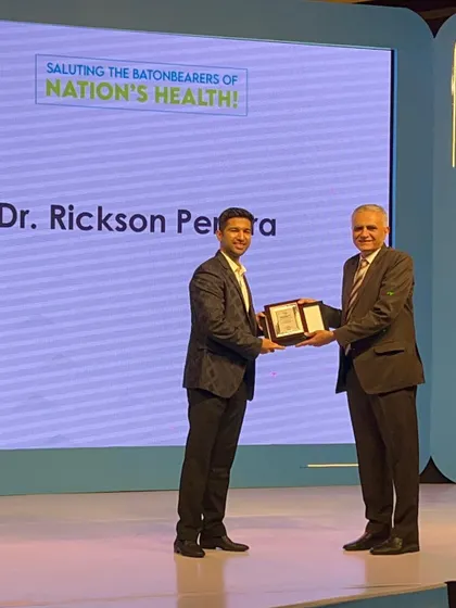 Receiving the award on stage. I am truly humbled by this recognition and grateful for the opportunity to contribute to the field of trichology.