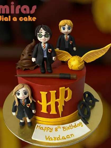 Step into the wizarding world with this detailed Harry Potter cake. It features hand-sculpted figurines of Harry, Ron, and Hermione, the golden snitch, a magic wand, and the iconic HP logo, all crafted from fondant for a truly magical birthday.