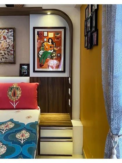 A close-up of the bedside detail, where an arched niche frames personal artwork. This shows how we incorporate our client's personality into the design.