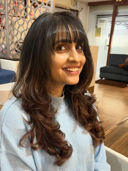 Wispy bangs and soft layers to work with a natural wavy texture.