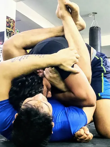 Position over submission, always. Here, a student is controlling his opponent with a triangle choke setup, demonstrating the importance of securing a dominant position before looking for the finish.