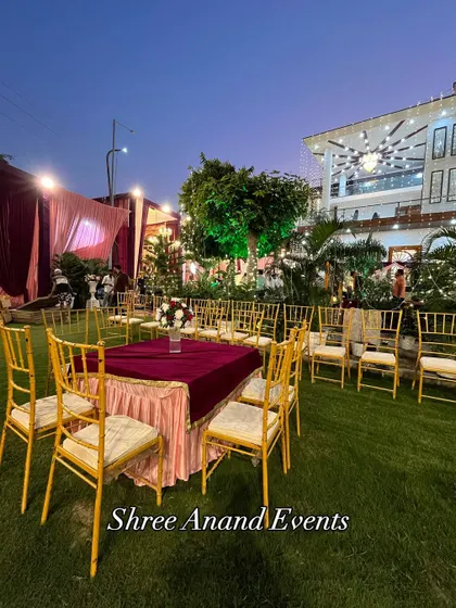 A simple yet elegant outdoor seating arrangement with gold chiavari chairs, perfect for a smaller gathering or ceremony.