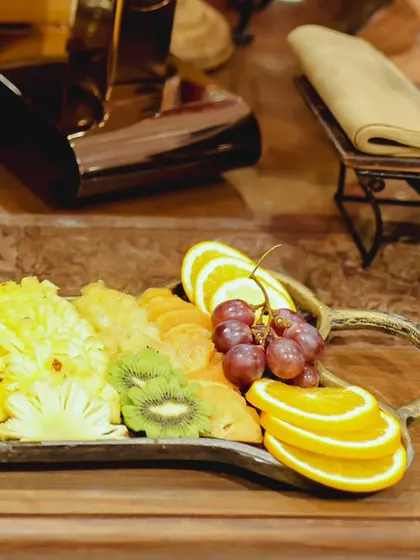 Another angle of our fresh fruit selection, highlighting sliced pineapple, kiwi, and oranges. These platters add a touch of color and freshness to any event.