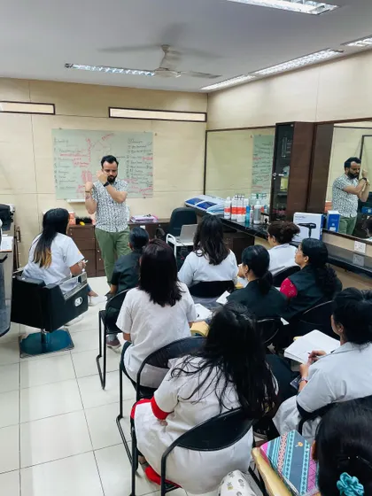 A wide view of our hair lab during a theory class. We ensure our students have a strong theoretical base before they start their practical training on the salon floor.