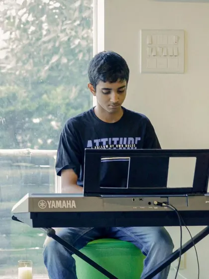 A young student at the keyboard during a recital. We provide a supportive environment for musicians of all levels.