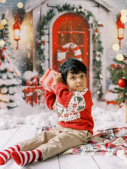 A little boy checking his present. The curiosity and anticipation of Christmas morning.