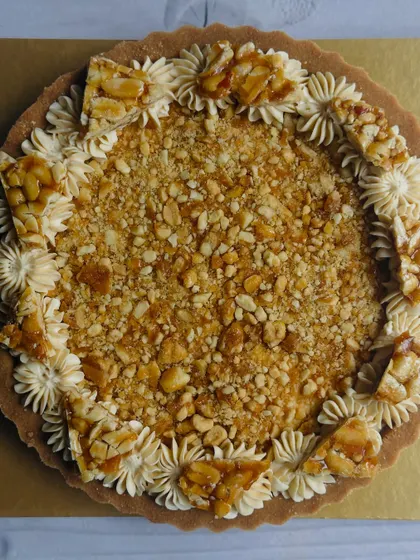 For Makar Sankranti, I make this Chikki-Top Peanut Butter Tart. It has a rich peanut butter cheesecake filling and is crowned with a crunchy, caramelized peanut chikki topping.