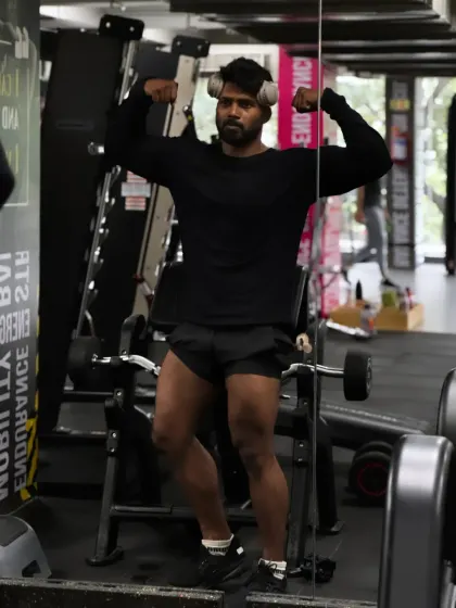 Flexing in the mirror to see the leg and arm definition. Every workout is a chance to sculpt your body.
