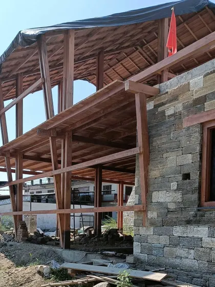 **Market Plaza, Champawat:** A detail showing how the new wooden structure connects to the existing stone building. This project combines new construction with respect for the existing context.