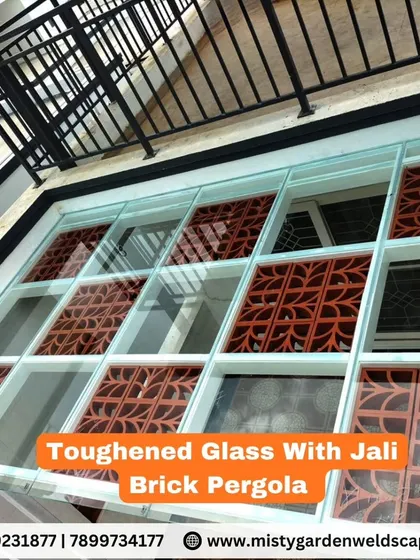 A pergola that combines toughened glass with decorative jali brick inserts. This unique design allows for natural light while adding an element of traditional artistry.