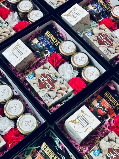 An angled view of the favor boxes, filled with a delightful assortment of treats and decorated with fresh flowers.