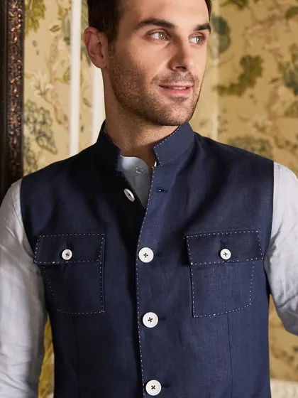 A close-up on the Hunter Waistcoat, highlighting the detailed stitching and the quality of the linen fabric. It's a piece that embodies crafted confidence.