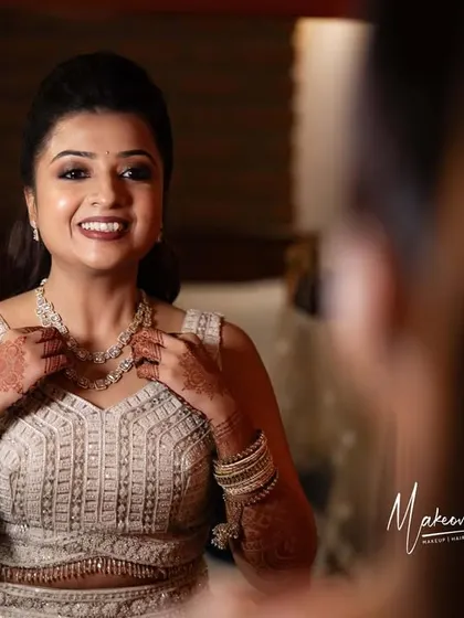 The bride's happy reflection as she gets ready for her Sangeet.