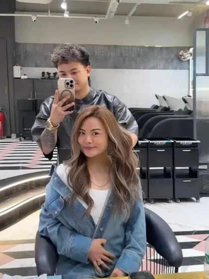 A mirror selfie with the client, showing off her new ash blonde balayage. The placement of the highlights is designed to be both beautiful and flattering.