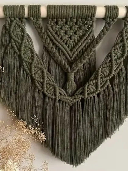 I also create my bohemian wall hangings in different colors. This piece in a deep olive green adds a touch of nature-inspired color and sophisticated texture to the wall.