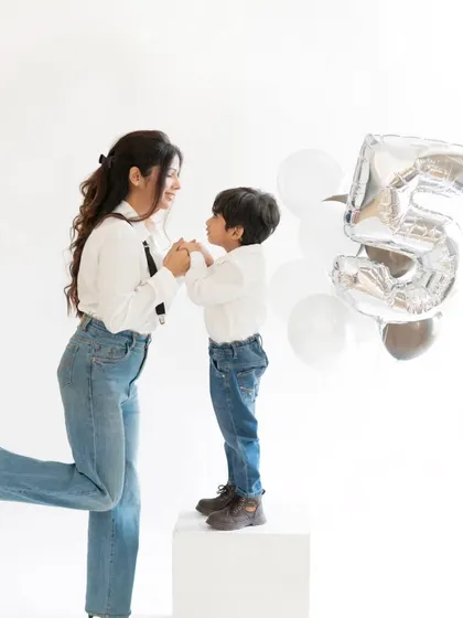 A sweet mother and son moment during his fifth birthday shoot. The simple, clean background puts all the focus on their loving interaction.