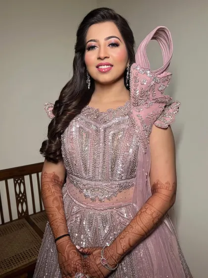 A smiling portrait of the bride, looking ready for a night of dancing.