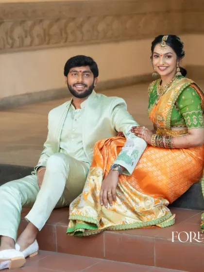 I designed this groom's light mint green bandhgala suit to create a fresh and modern color story with the bride's orange and green saree. This is a great example of coordinating colors without matching them exactly.