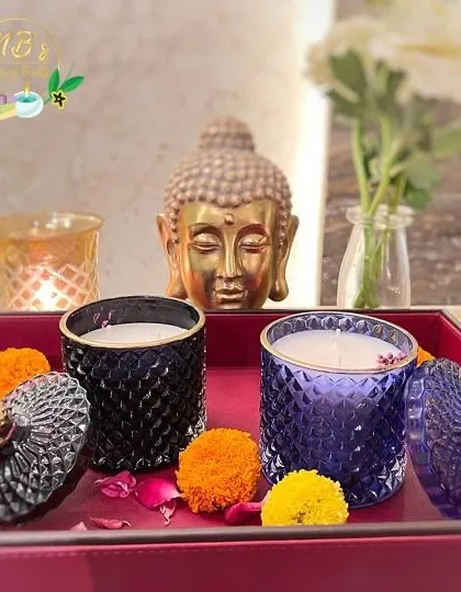 My crystal jar candles look beautiful when styled in your home. Here, the black and purple jars are set on a tray with marigold flowers, creating a serene and festive atmosphere perfect for Diwali.