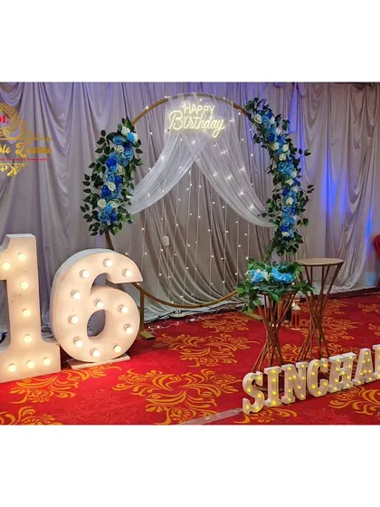 Another view of the floral and light-up 16th birthday decoration.
