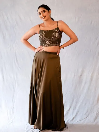 A full-length shot of an olive green two-piece outfit. The confident pose shows off the entire look, perfect for a fashion portfolio.