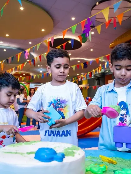 Three boys enjoying the sensory sand table during our Holi celebration. It's a great activity for creative and imaginative play, no matter the occasion.