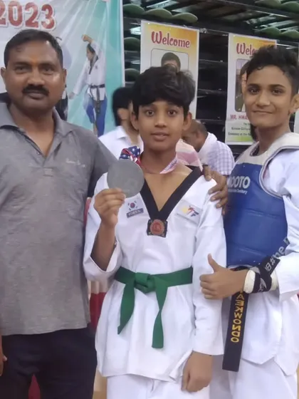 Posing with my students after a successful competition. Their medals are a reward for their dedication.