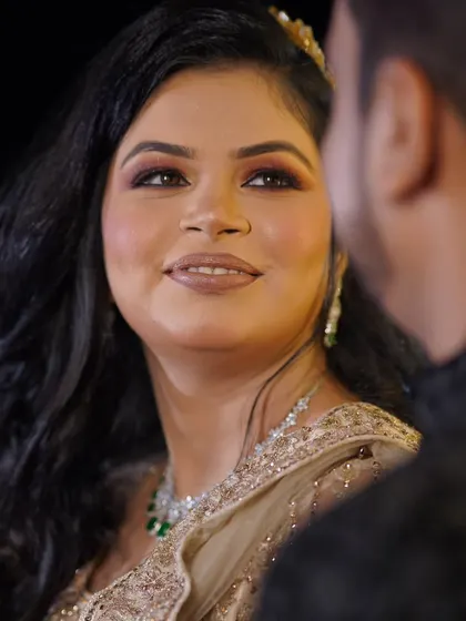 A close-up, candid moment during a conversation. The bride's soft smile as she looks at her partner is a beautiful, unposed memory.