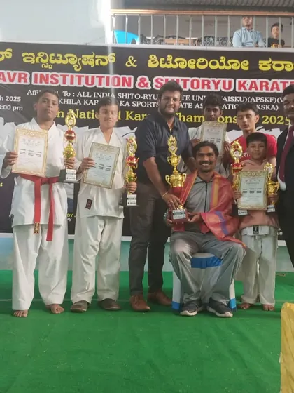 A group of my students and I with our trophies from the 11th Open National Karate Championship 2025, where we secured multiple top positions.