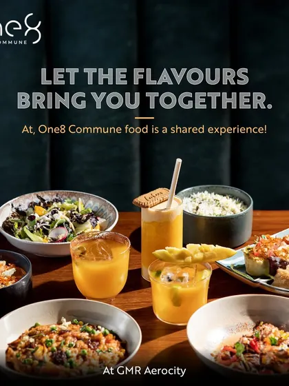 At One8 Commune, food is a shared experience that brings people together. This image displays a vibrant spread of global dishes and drinks, perfect for a communal feast.