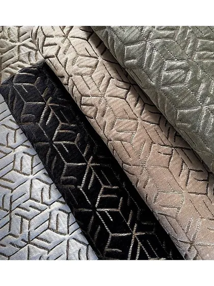 The 'MOBEL' jacquard fabric combines matte and shine in a geometric pattern. It's suitable for both seating and curtains, as it has a beautiful weight and drape.