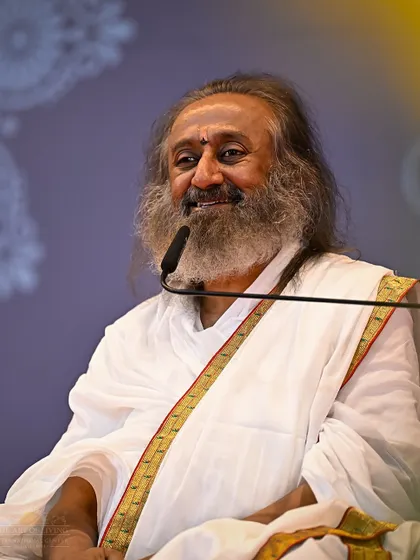 A smiling portrait of me during a knowledge session. My goal is to make the most profound wisdom light and accessible, so that it brings not just understanding but also joy and a sense of effortlessness.
