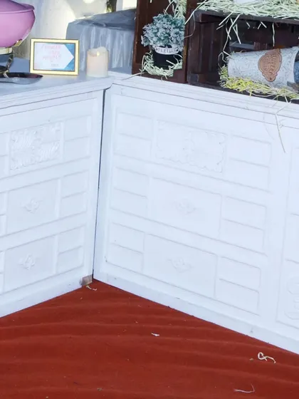 A close-up of the detailed paneling on our white buffet counters. We believe even the functional elements of an event should be stylish and well-crafted.