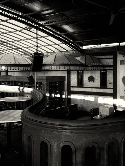 A dynamic view of the curved balcony and the bar canopies, showcasing the interplay of the major architectural forms in the space.