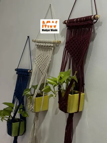 A set of three colorful wall plant hangers in navy, beige, and maroon. These are perfect for beautifying any wall, balcony, or entrance.