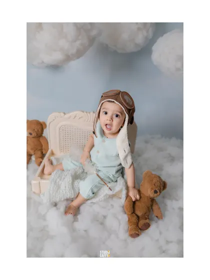 Another adorable shot of our little pilot surrounded by fluffy clouds and teddy bears.