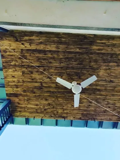 A close-up of the burnt-finish bamboo ceiling, adding a rustic and natural texture to the modern pergola structure.
