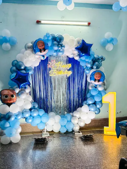 A close-up of the Boss Baby balloon ring, featuring a neon 'Happy Birthday' sign and character balloons.